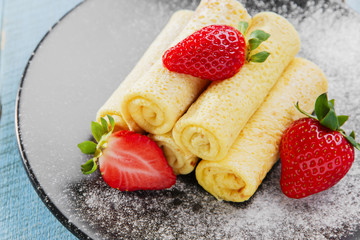 rolled pancakes with strawberries breakfast