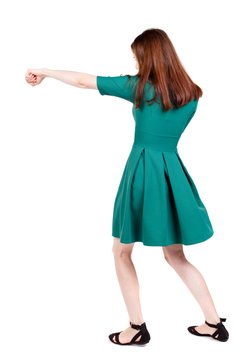 skinny woman funny fights waving his arms and legs. I The slender brunette in a green short dress has outstretched arm.