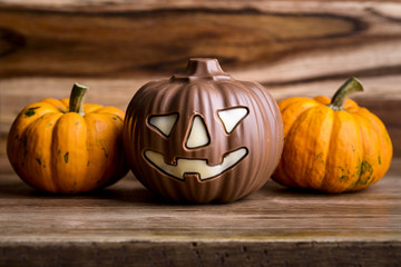 pumpkins and chocolate pumpkin on wood for halloween