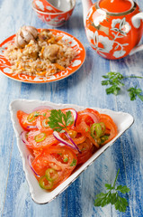 Vegetable salad from tomatoes with onions and hot peppers