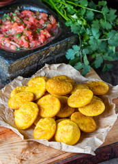 Obraz na płótnie Canvas Latin American food. Traditional chilenian homemade pumpkin sopaipillas with salsa