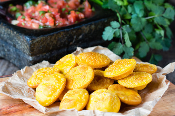 Latin American food. Traditional chilenian homemade pumpkin sopaipillas with salsa