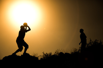 two brothers, boys play at sunset.