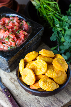 Latin American food. Traditional chilenian homemade pumpkin sopaipillas with salsa