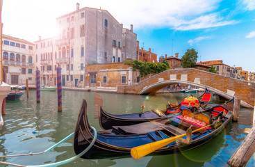 Beautiful scene with traditional gondola and canal in Venice, Italy