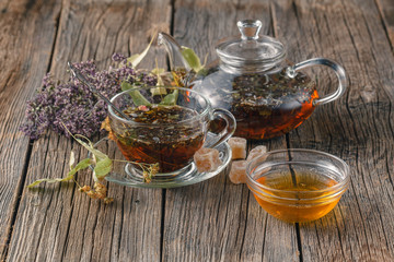 Cup of herbal tea with wild flowers and various herbs