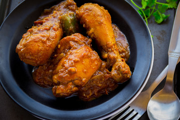 Chicken curry in a dark background.