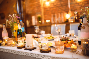 Beautiful decorated wedding table. candles on the table during the evening wedding dinner
