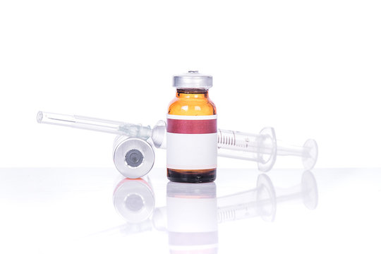 Glass Medicine Vials with botox, hualuronic, collagen or flu Syringe on table