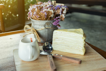 Crape cake dessert set on wooden table in cafe