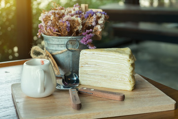 Crape cake dessert set on wooden table in cafe
