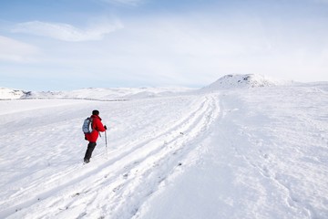 Fototapeta na wymiar Woman hiking in snow