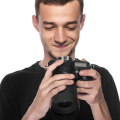 Fototapeta premium Handsome young man holding a DSLR camera.