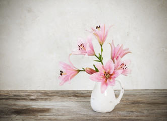 lily in vase on background old white wall