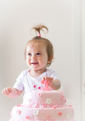 1year old baby girl celebrating birthday,and playing with the birthday cake