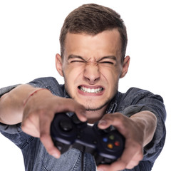 Young man playing on console or computer.