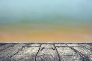 Fototapeta na wymiar Old wooden floor table. Blurred background sea.blurred natural sea beach sky summer backdrop wall with old brown wood colored background