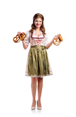 Beautiful woman in traditional bavarian dress holding pretzels