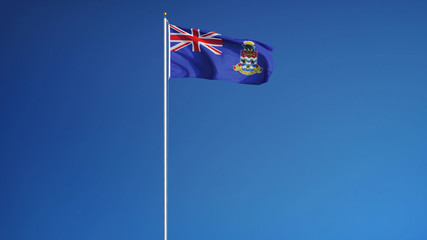 Cayman Islands flag waving against clean blue sky, long shot, isolated with clipping path mask...