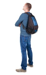Fototapeta premium Back view of man with photographic backpack looking up. Rear view people collection. backside view of person. Isolated over white background. guy in the green t-shirt stands with a suitcase on
