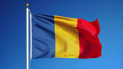 Chad flag waving against clean blue sky, close up, isolated with clipping path mask alpha channel...