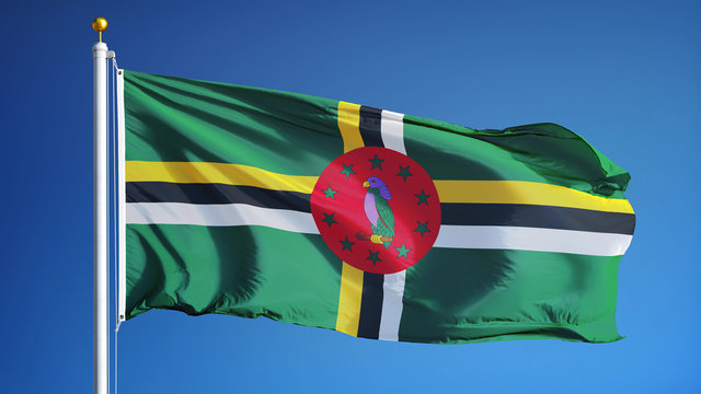 Dominica flag waving against clean blue sky, close up, isolated with clipping path mask alpha channel transparency - Powered by Adobe