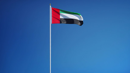 Emirates flag waving against clean blue sky, seamlessly looped long shot, isolated with clipping path mask alpha channel transparency
