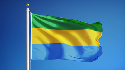 Fototapeta na wymiar Gabon flag waving against clean blue sky, close up, isolated with clipping path mask alpha channel transparency
