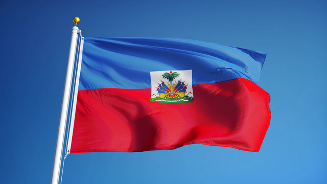 Haiti flag waving against clean blue sky, close up, isolated with clipping path mask alpha channel transparency