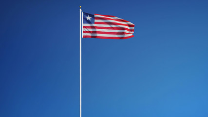 Liberia flag waving against clean blue sky, long shot, isolated with clipping path mask alpha...