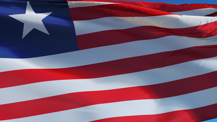 Liberia flag waving against clean blue sky, close up, isolated with clipping path mask alpha channel transparency