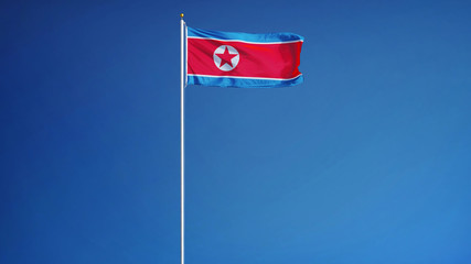 North Korea flag waving against clean blue sky, long shot, isolated with clipping path mask alpha channel transparency