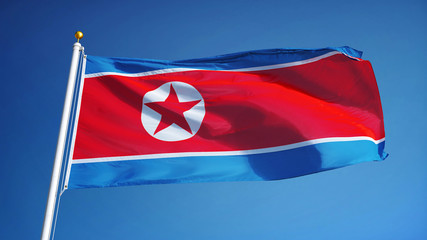 Naklejka premium North Korea flag waving against clean blue sky, close up, isolated with clipping path mask alpha channel transparency