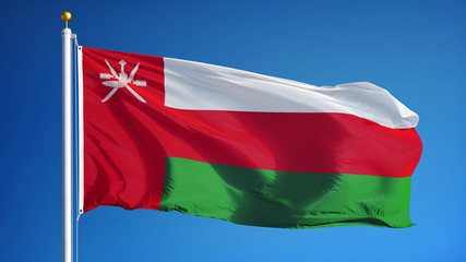Fototapeta na wymiar Oman flag waving against clean blue sky, close up, isolated with clipping path mask alpha channel transparency