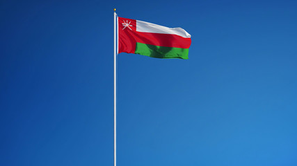 Fototapeta na wymiar Oman flag waving against clean blue sky, long shot, isolated with clipping path mask alpha channel transparency