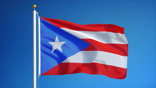 Puerto Rico flag waving against clean blue sky, close up, isolated with clipping path mask alpha channel transparency