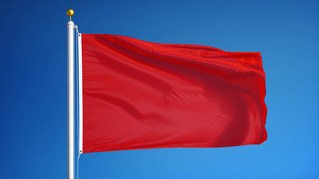 Red flag waving against clean blue sky, close up, isolated with clipping path mask alpha channel transparency