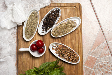 Fresh meat selection on wooden cutting board with spices in a wh