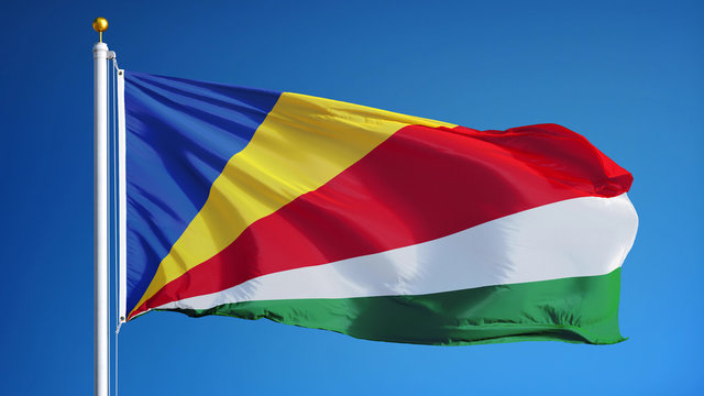 Seychelles flag waving against clean blue sky, close up, isolated with clipping path mask alpha channel transparency