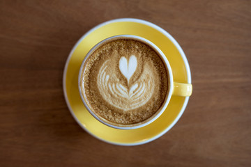 Hot latte art on wood table
