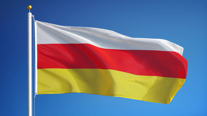 South Ossetia flag waving against clean blue sky, close up, isolated with clipping path mask alpha channel transparency