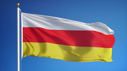 South Ossetia flag waving against clean blue sky, close up, isolated with clipping path mask alpha channel transparency