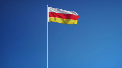 Fototapeta na wymiar South Ossetia flag waving against clean blue sky, long shot, isolated with clipping path mask alpha channel transparency