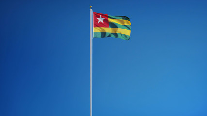 Togo flag waving against clean blue sky, long shot, isolated with clipping path mask alpha channel transparency