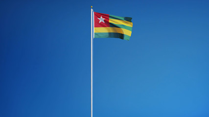 Togo flag waving against clean blue sky, long shot, isolated with clipping path mask alpha channel transparency
