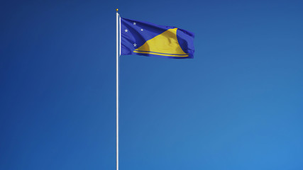 Tokelau flag waving against clean blue sky, long shot, isolated with clipping path mask alpha channel transparency