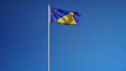 Tokelau flag waving against clean blue sky, long shot, isolated with clipping path mask alpha channel transparency