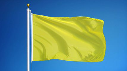 Bright yellow flag waving against clean blue sky, close up, isolated with clipping path mask alpha channel transparency