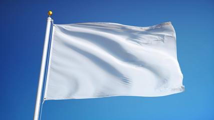 Naklejka premium Empty white clear flag waving against clean blue sky, close up, isolated with clipping path mask alpha channel transparency