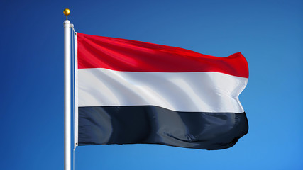 Fototapeta na wymiar Yemen flag waving against clean blue sky, close up, isolated with clipping path mask alpha channel transparency